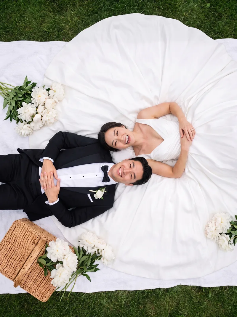 AI-generated couple photo example: Picnic From Above — Overhead shot, gown fanned in a circle